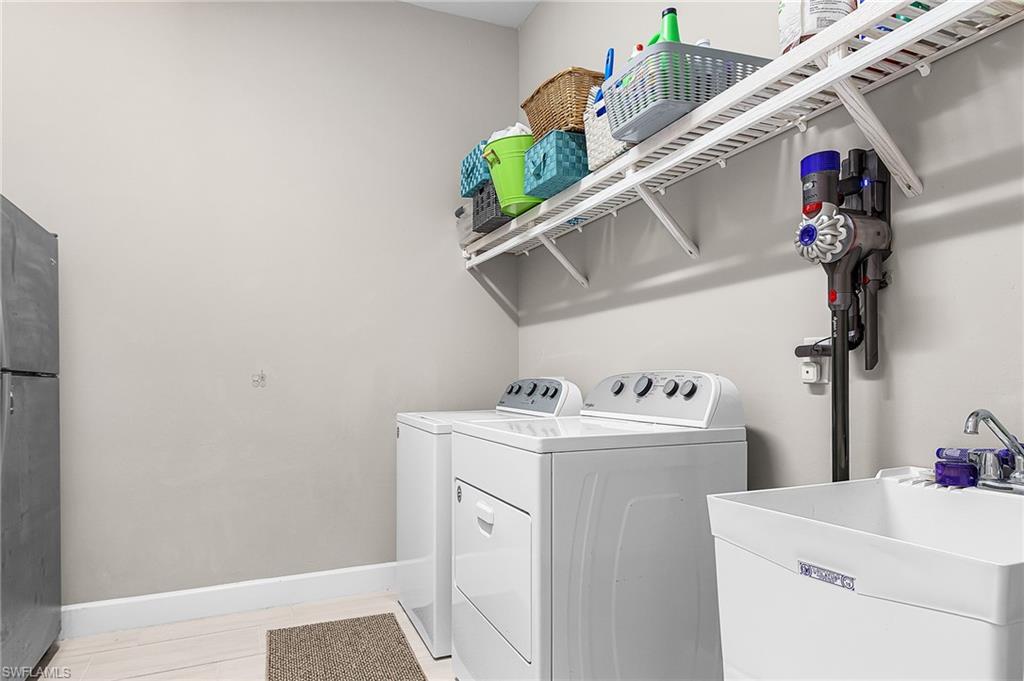 Laundry area featuring baseboards and separate washer and dryer
