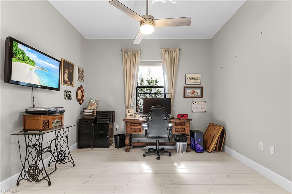 Home office with baseboards and ceiling fan
