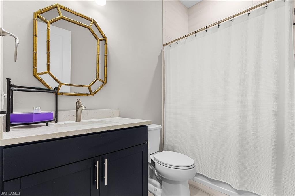 Full bathroom with toilet and vanity