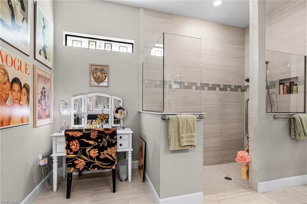 Full bath featuring baseboards and tiled shower