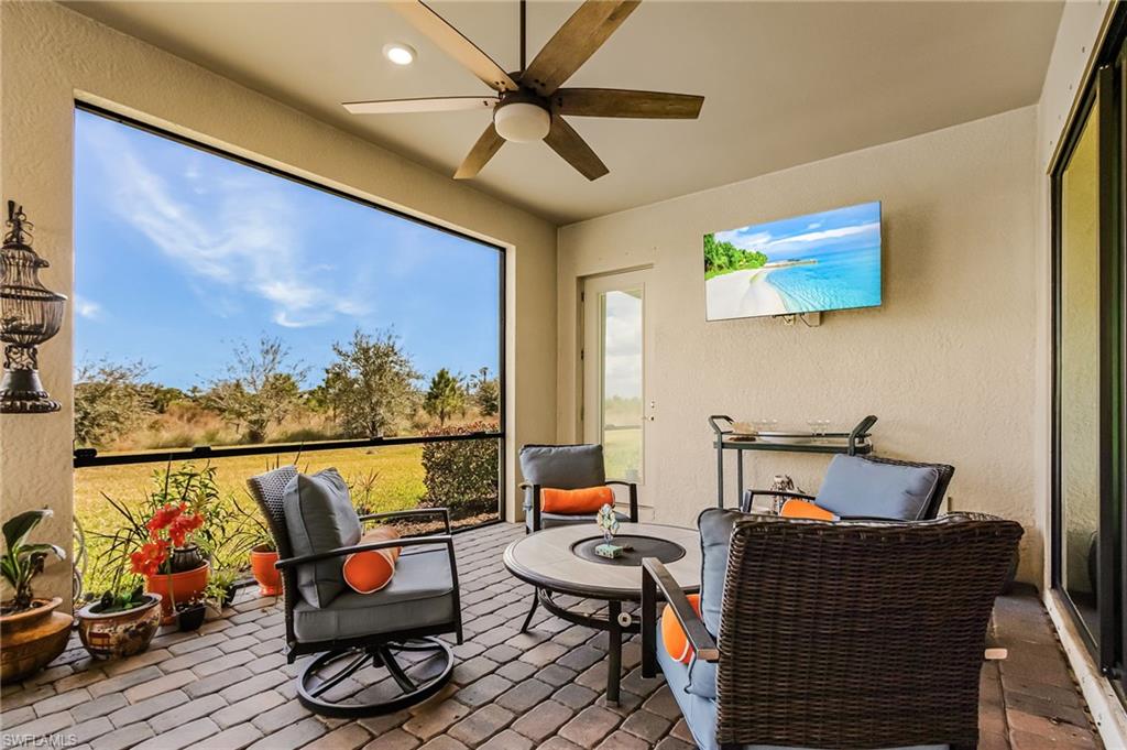 Sunroom / solarium featuring ceiling fan