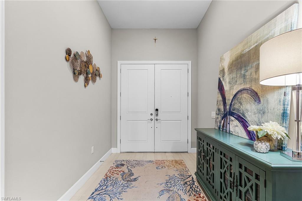 Entryway with baseboards and wood finished floors