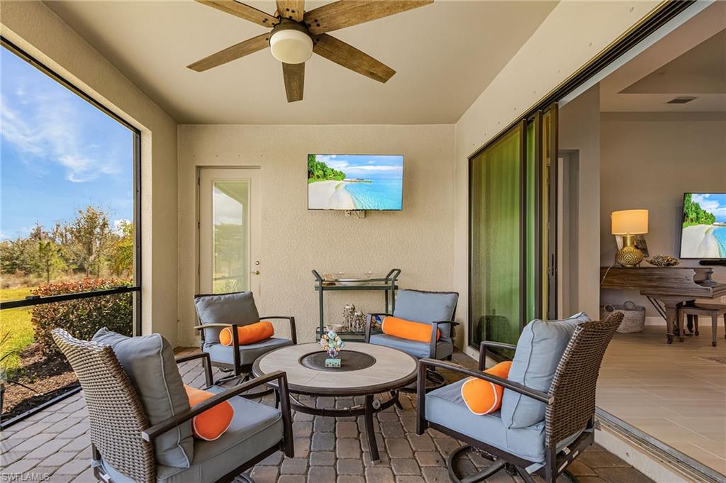 Sunroom featuring a ceiling fan and outdoor furniture