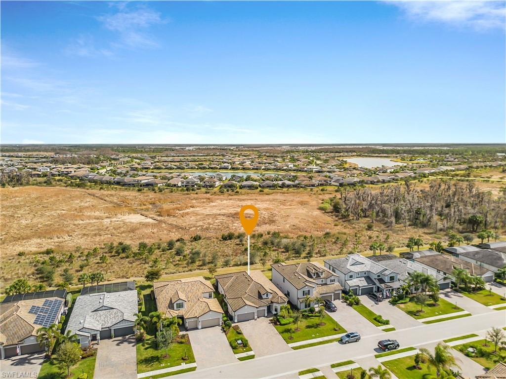 Aerial perspective of suburban area featuring a large body of water