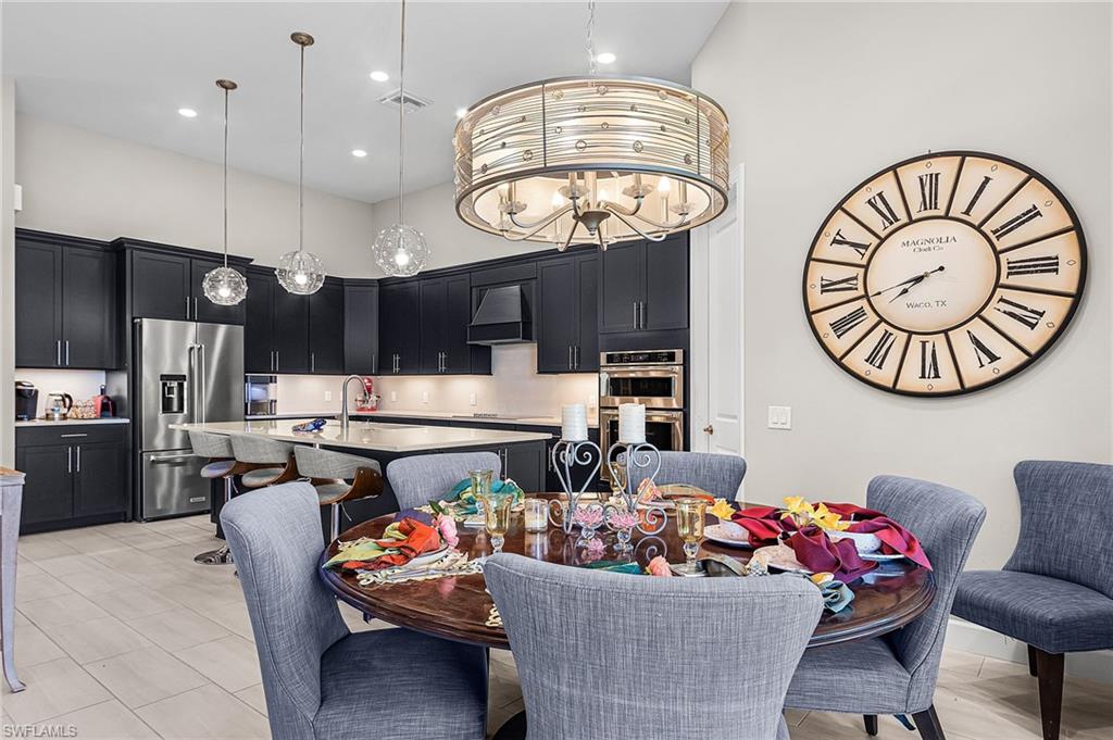 Dining room featuring a high ceiling and hanging lights