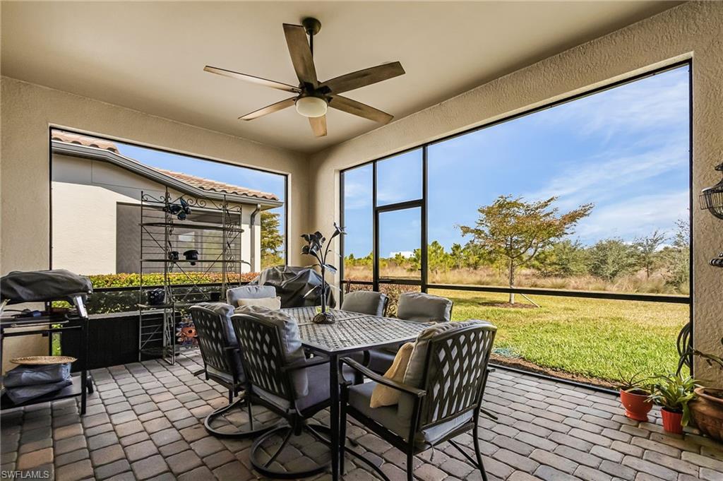 Sunroom featuring a ceiling fan, outdoor dining area, and a patio area