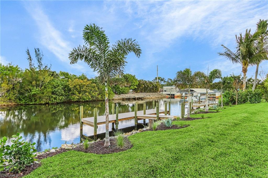 Dock featuring a water view and a yard