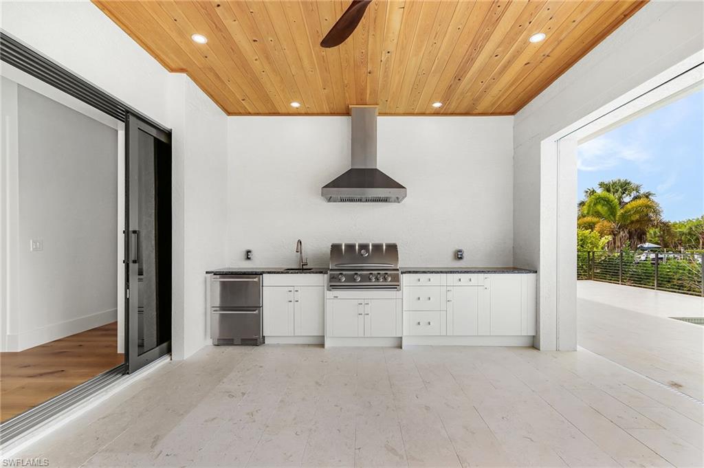 View of patio / terrace featuring area for grilling and ceiling fan
