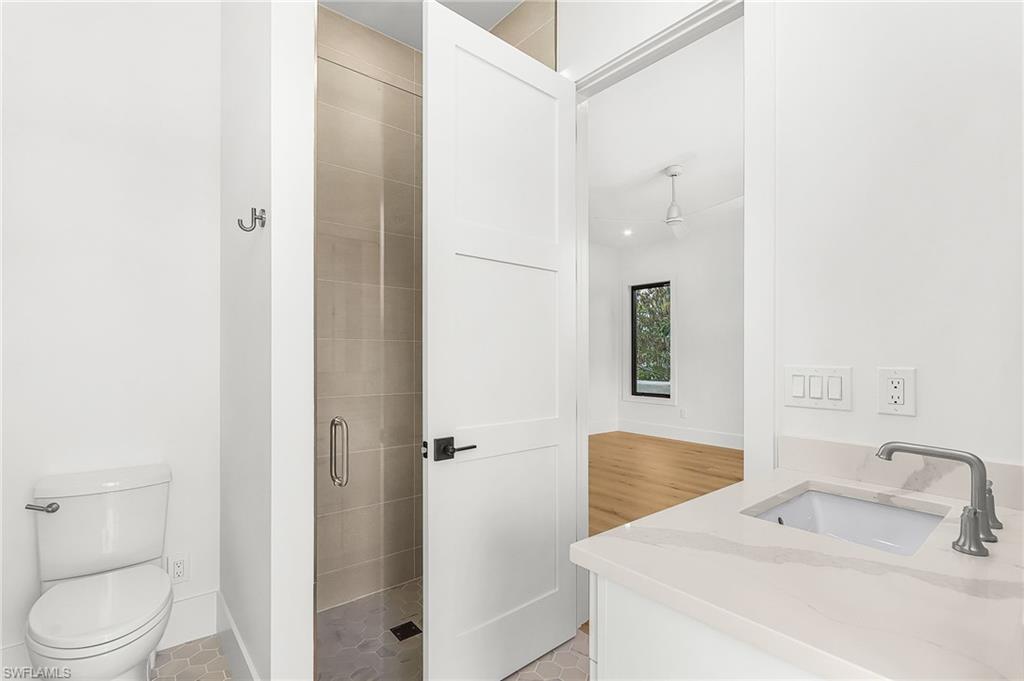 Full bathroom featuring vanity, a stall shower, and light tile patterned floors