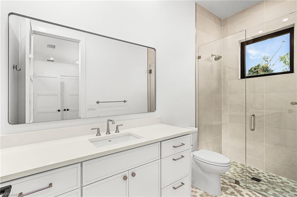 Bathroom with vanity and a shower stall