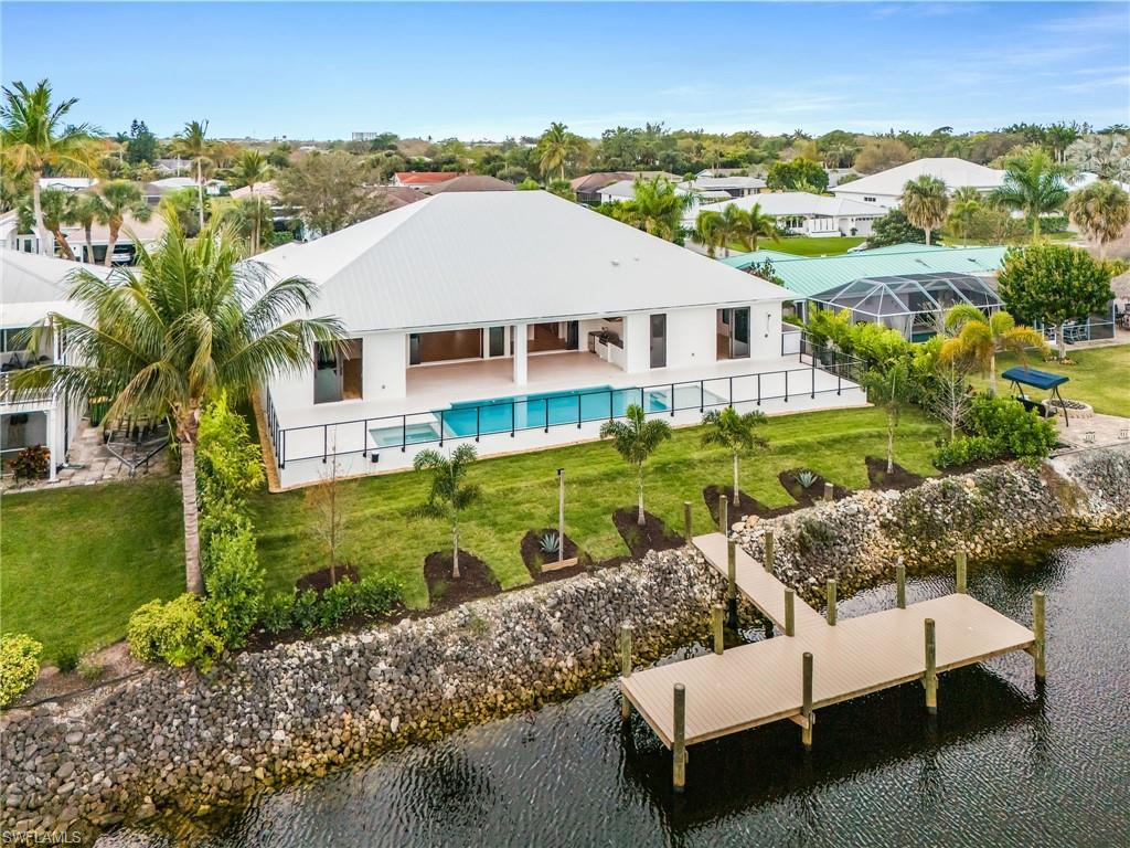 Back of property with a patio and a water view
