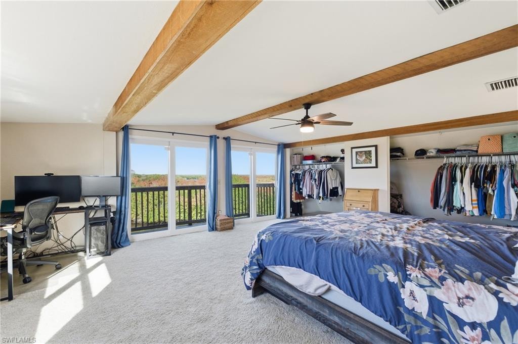 Tiled bedroom with a ceiling fan, a crib, and lofted ceiling with beams