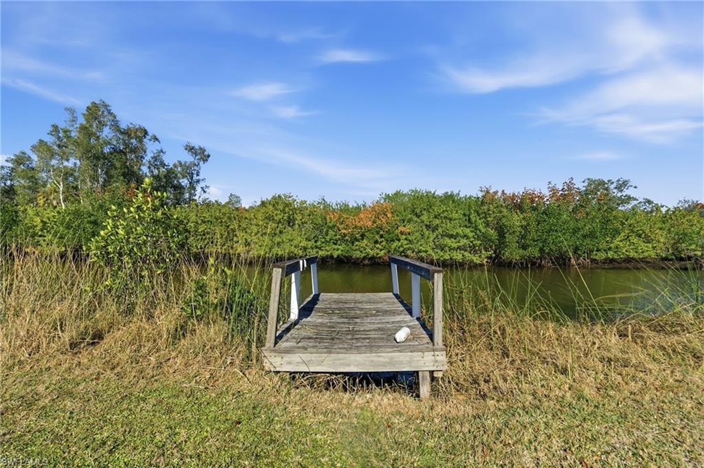 Dock area featuring a water view