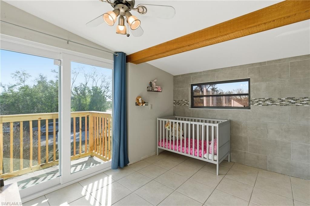 Bedroom with beamed ceiling, ceiling fan, access to outside, and light tile patterned flooring