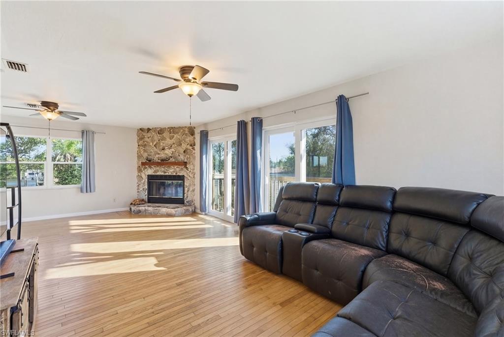 Living room featuring light wood-type flooring and a ceiling fan