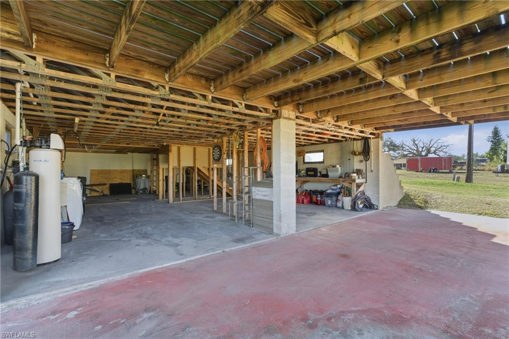 Basement featuring a water pressure tank and separate washer and dryer