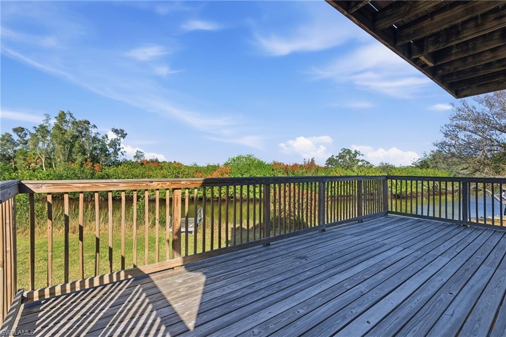 Wooden terrace featuring a yard