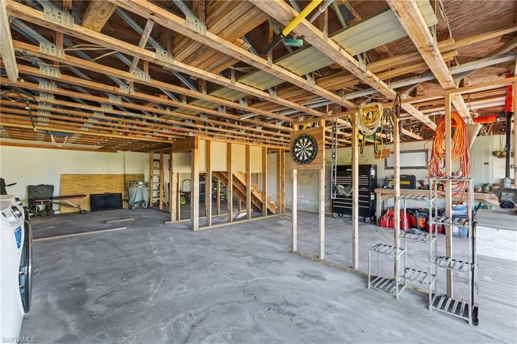 Miscellaneous room with unfinished concrete flooring and independent washer and dryer