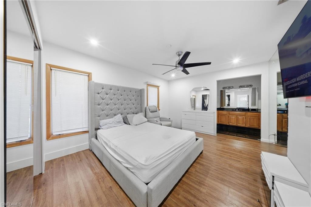 Bedroom with light wood-style flooring, a ceiling fan, and recessed lighting