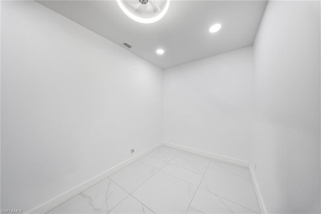 Empty room featuring recessed lighting and light marble finish floors