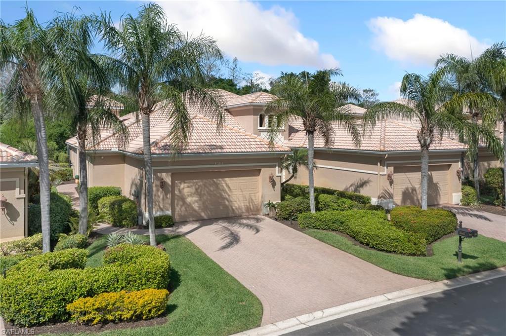 Mediterranean / spanish-style home featuring a garage, a tiled roof, decorative driveway, and stucco siding
