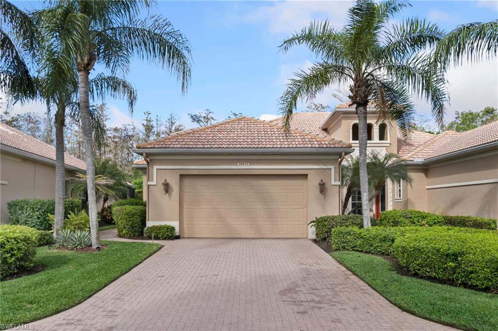 Mediterranean / spanish-style house featuring a garage, decorative driveway, a tile roof, and stucco siding