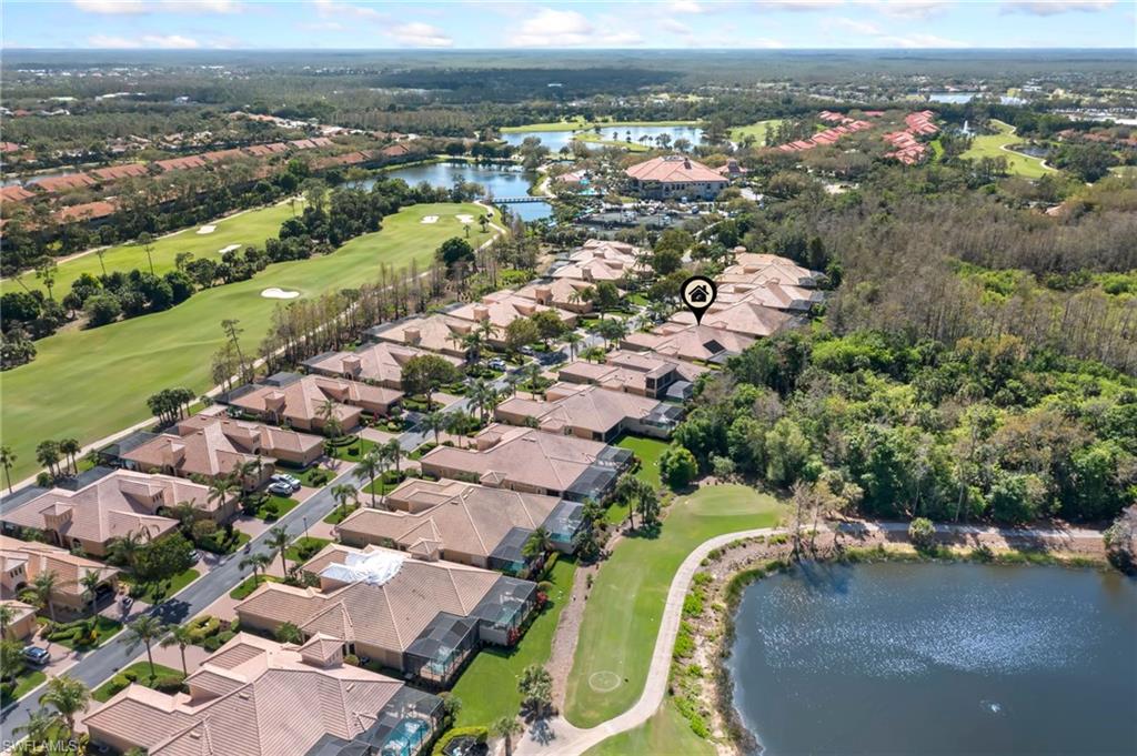 Birds eye view of property featuring golf course view, a water view, and a residential view