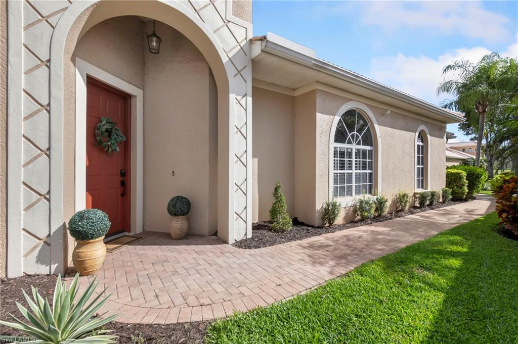 Entrance to property featuring stucco siding
