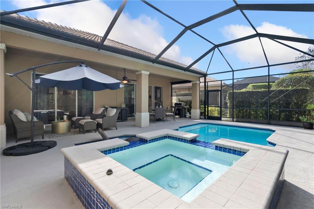 View of swimming pool with a pool with connected hot tub, outdoor lounge area, a patio area, ceiling fan, and a lanai
