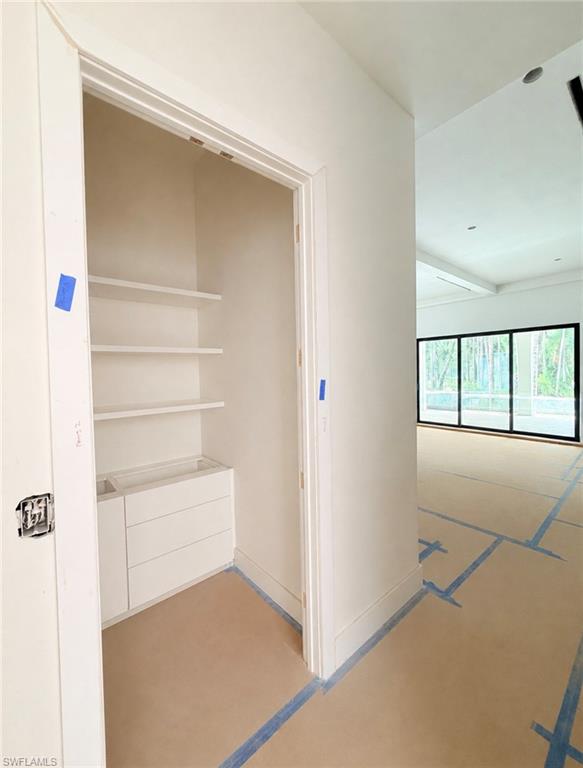 Built-in closet shelving, integrated drawer storage, and recessed lighting