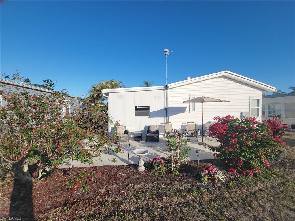 Rear view of property featuring a yard and a patio area