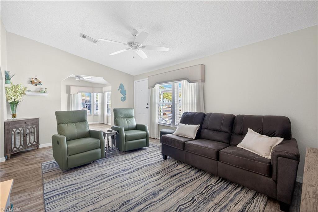 Living area with wood finished floors and a ceiling fan