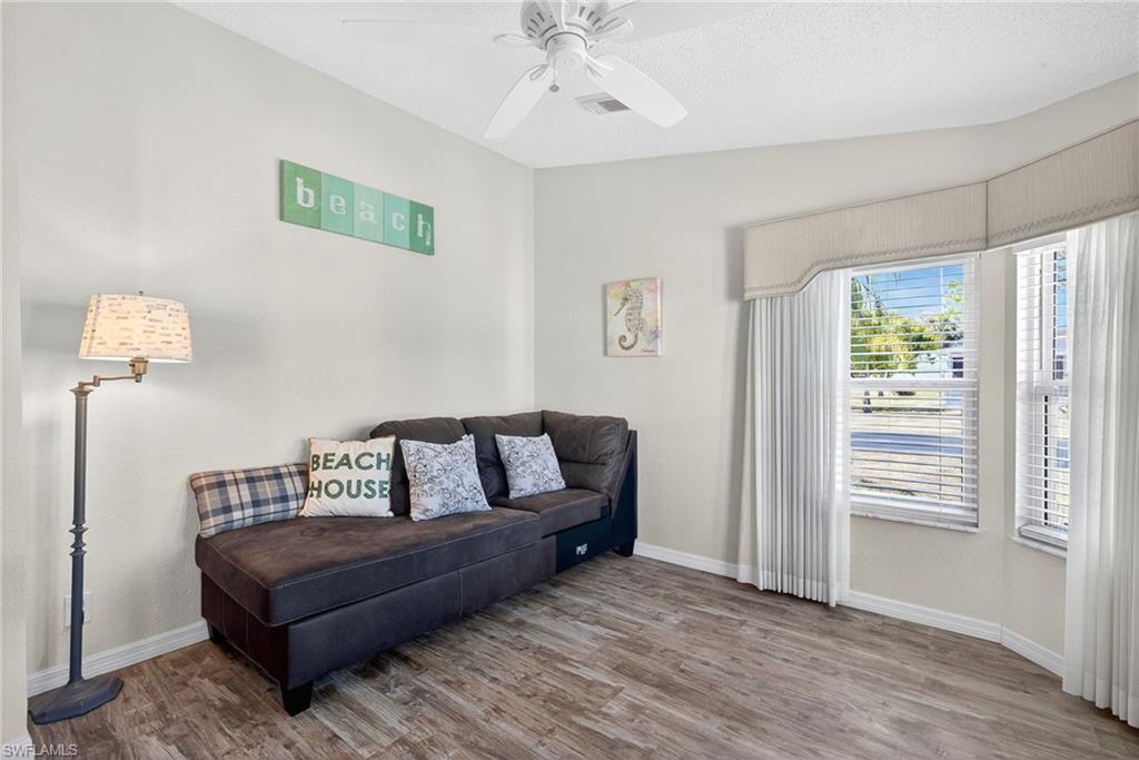 Sitting room featuring wood finished floors and a ceiling fan