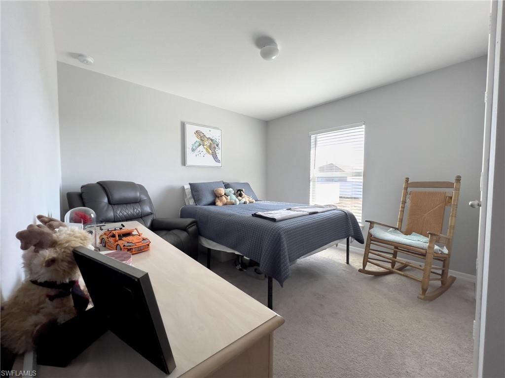 Bedroom with light carpet