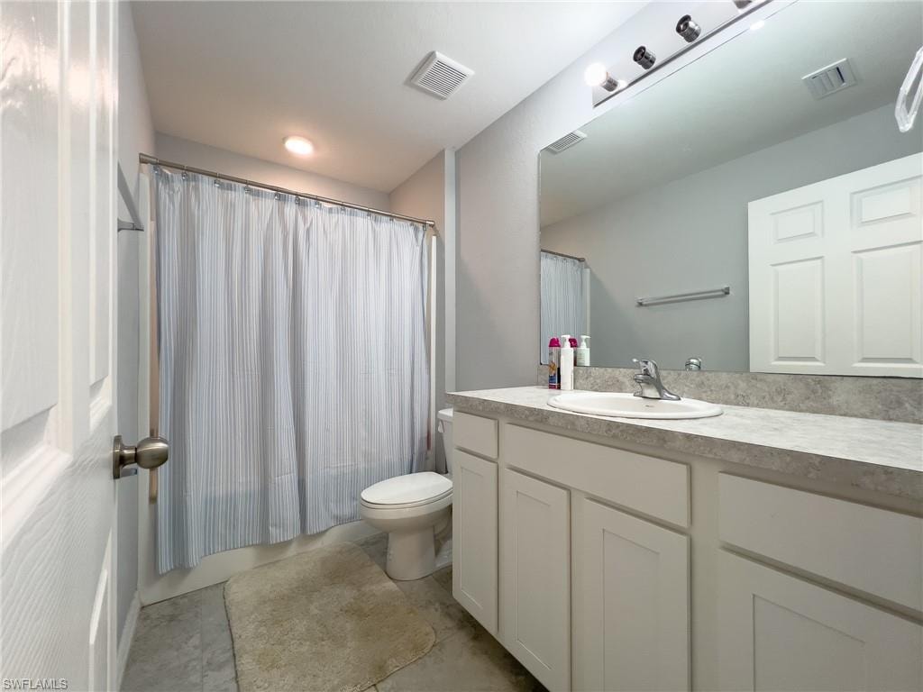 Full bathroom with vanity and shower / bath combo with shower curtain