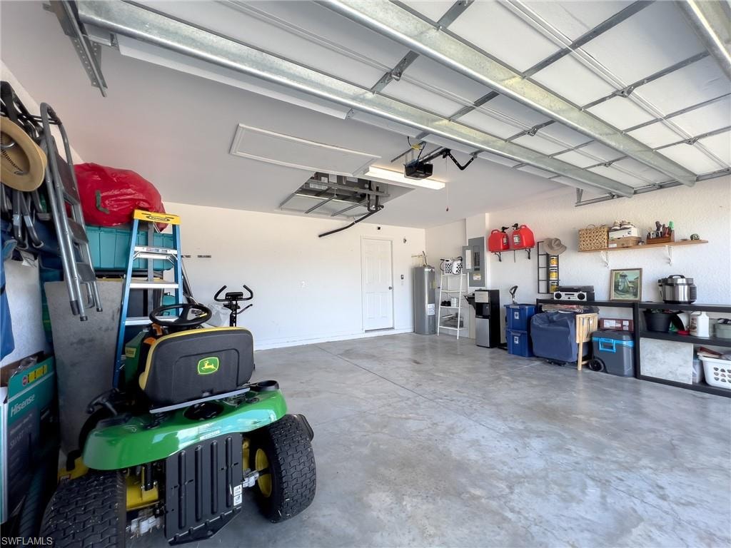 Garage featuring water heater and electric panel