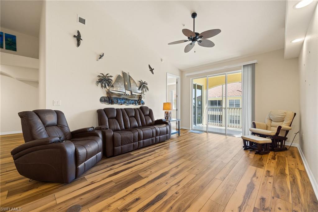 Living room featuring wood-type flooring and a ceiling fan