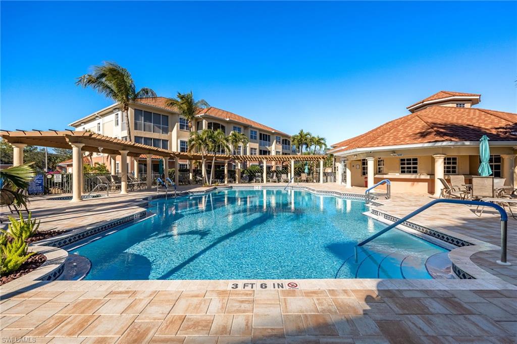 Community pool featuring a patio and a pergola