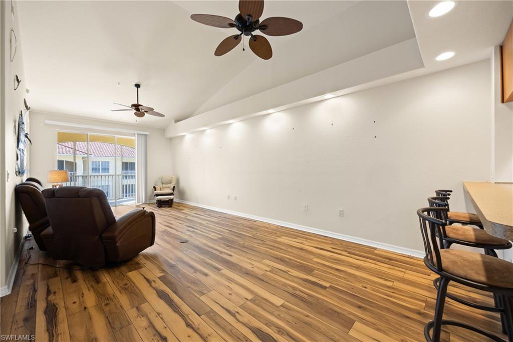 Sitting room featuring vaulted ceiling, wood-type flooring, a ceiling fan, and recessed lighting