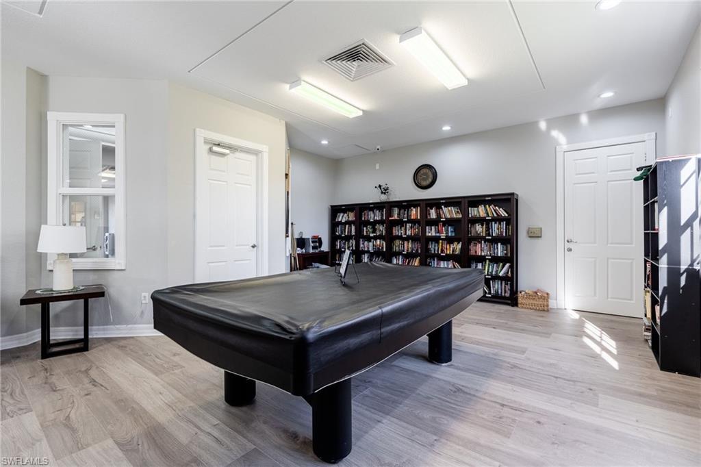 Rec room with light wood finished floors, billiards, and recessed lighting