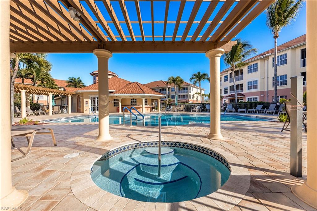 Community pool with a patio, a pergola, and a community hot tub