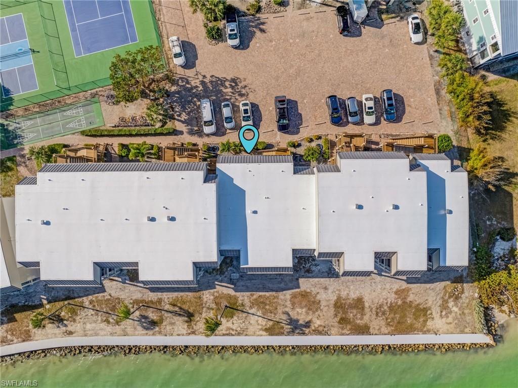 Tropical landscaping, walking decks, and waterfront pathways enhance the island setting.