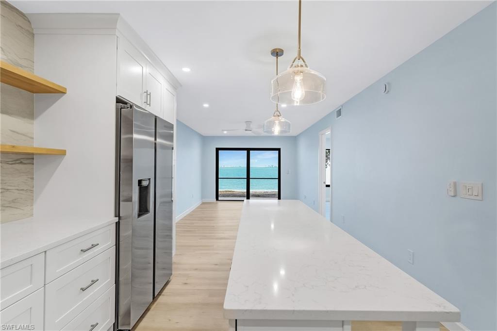 Welcome to easy island living from this beautifully remodeled first-floor bayfront condo.