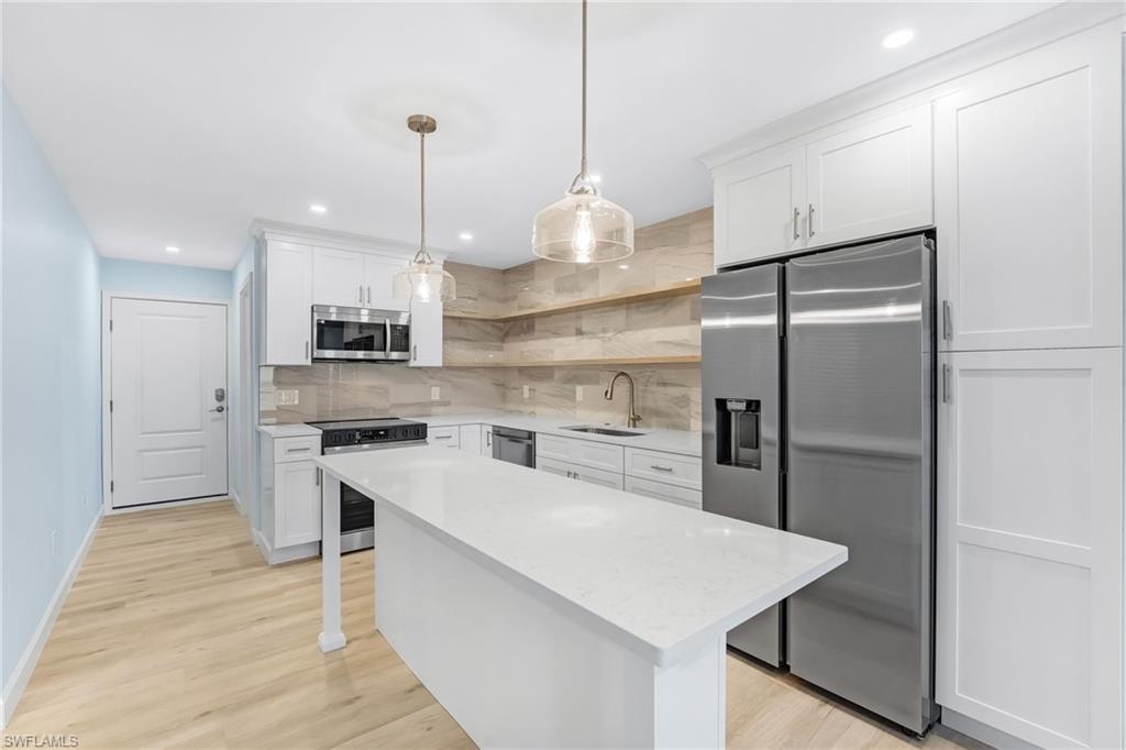 The redesigned kitchen features all-wood cabinetry, quartz countertops, and all-new stainless-steel appliances.