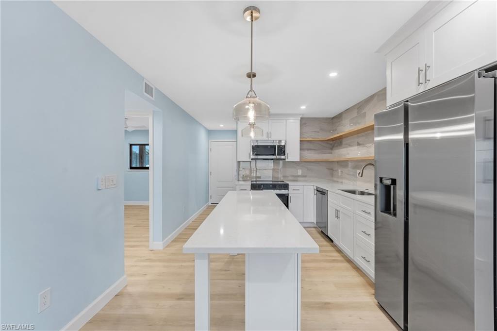 A convenient breakfast bar adds casual seating and an easy flow for entertaining.