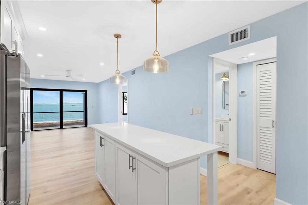 Enjoy bay views from the main living and dining spaces the moment you walk in.