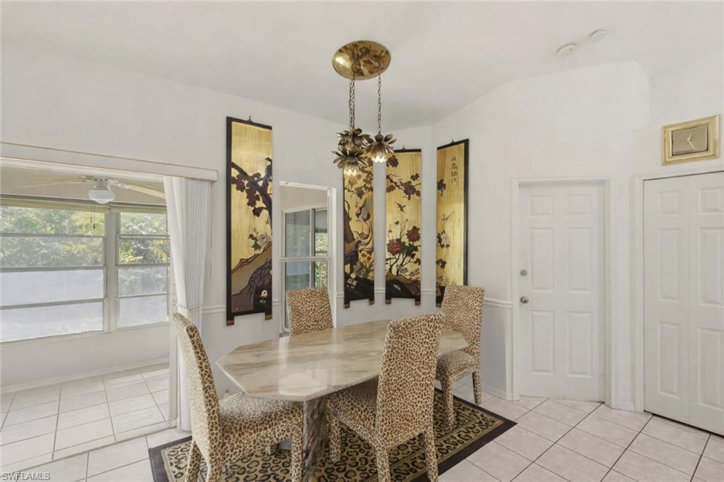 Dining room featuring light tile patterned flooring and hanging lights