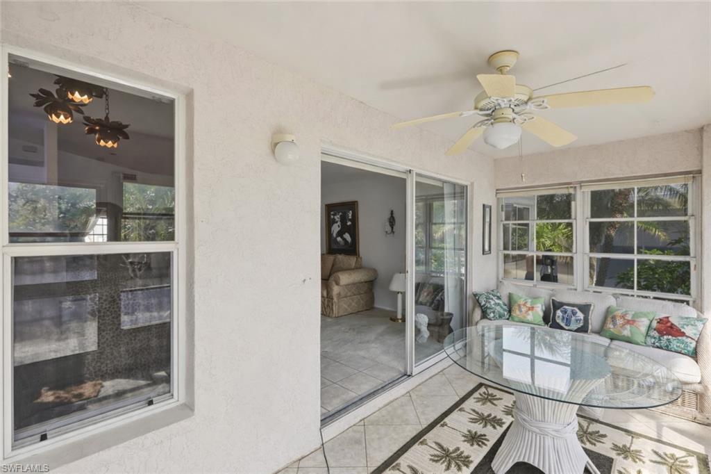 Sunroom featuring ceiling fan, a patio, and healthy amount of natural light
