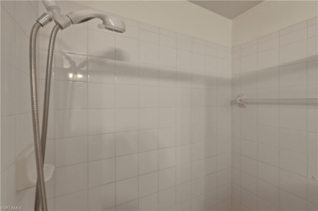 Full bath featuring a tile shower