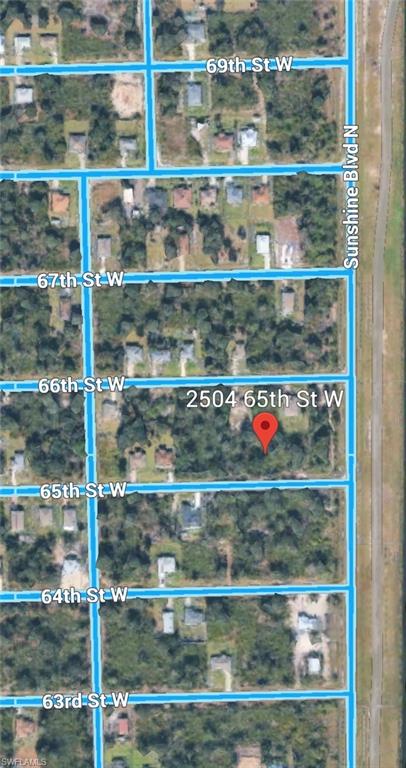 Aerial view of residential area featuring property boundaries highlighted and a nearby body of water